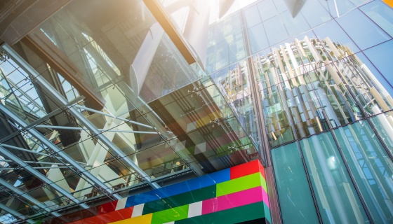 Looking up at a glass building and artwork at Jellicoe Street in Auckland